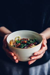 Woman holding bowl of soup