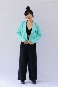 Young woman standing against white background