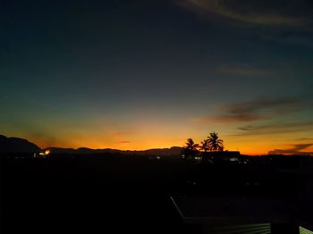 Silhouette landscape against sky during sunset