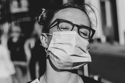 Close-up of woman wearing flu mask