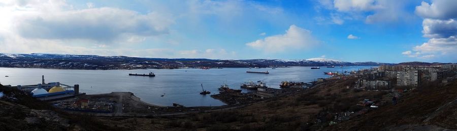 Panoramic view of city by sea against sky