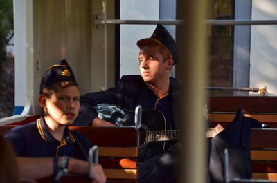 Portrait of teenage boy sitting in window