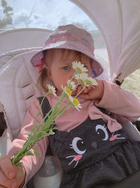 Portrait of cute girl drinking flower