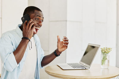 Young woman using mobile phone in office