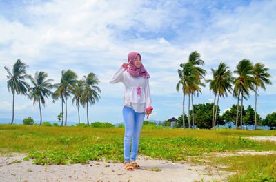 Thoughtful woman standing on land