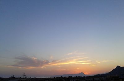 Silhouette cityscape against clear sky during sunset