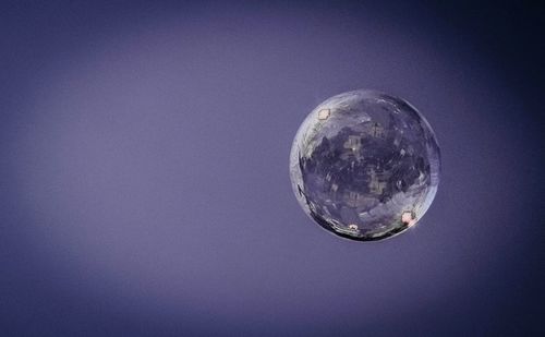 Low angle view of bubbles against sky at night