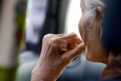 Close-up of senior woman against blurred background