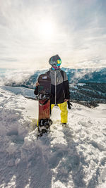 Rear view of man skiing on snow covered landscape