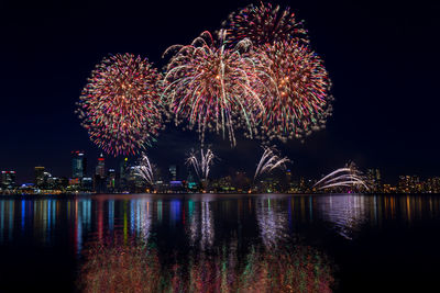 Firework display over city at night