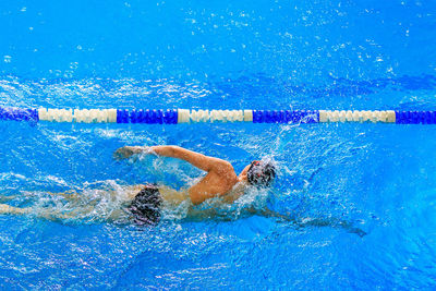 High angle view of man swimming in pool