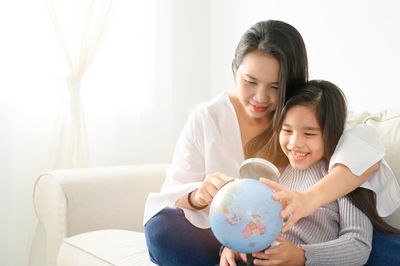 Mother and daughter holding baby