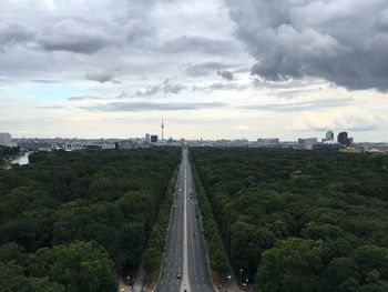 High angle view of road in city against cloudy sky