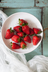 High angle view of strawberries in bowl on table