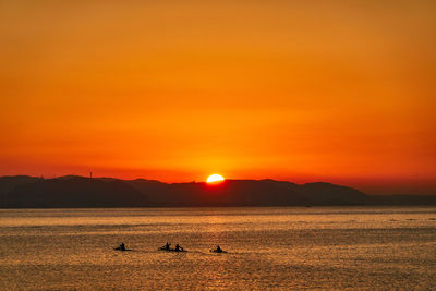 Scenic view of sea against orange sky