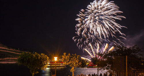 Firework display over river at night