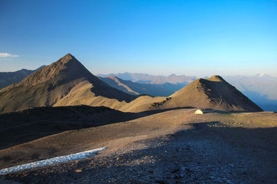 Scenic view of mountains against clear blue sky