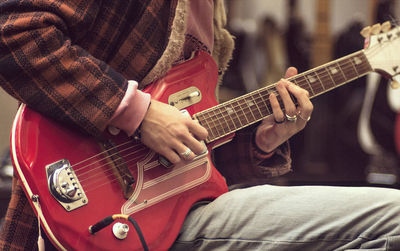 Cropped image of man playing guitar