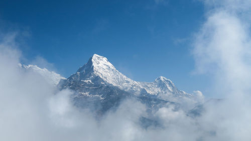 Low angle view of snowcapped mountains against sky