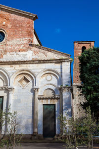 Low angle view of old building against blue sky