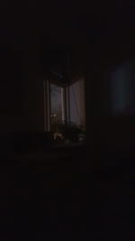 Low angle view of window in dark room