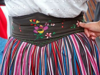 Midsection of woman standing in traditional clothing