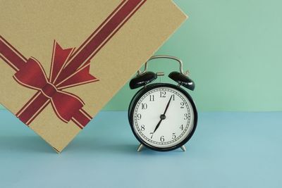 Directly above shot of alarm clock on blue background