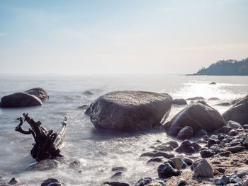 Rocks on beach against sky