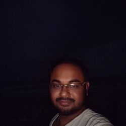 Portrait of young man against black background