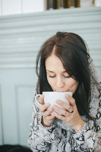 Young woman with cup of coffee