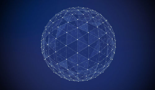 Abstract image of sparkling sphere against blue background