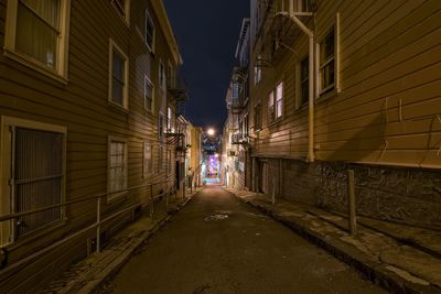 Walkway in city at night