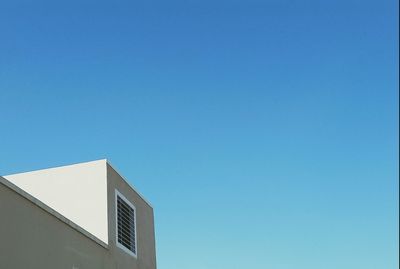 Low angle view of building against clear blue sky