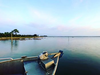 Boat moored in sea against sky