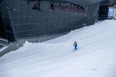 Man skiing on snow covered field