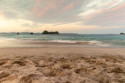 Scenic view of beach against sky during sunset