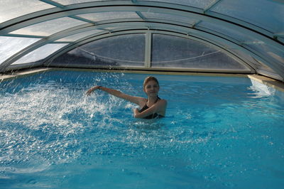 Portrait of a young man swimming in pool