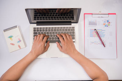 Low section of person using laptop on table
