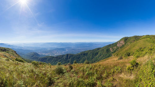 Scenic view of mountains against blue sky