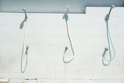 Bathroom equipment attached on tiled wall