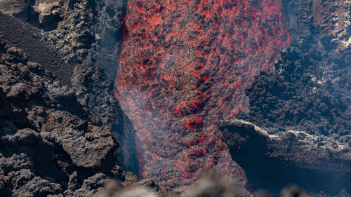 Etna- lava flow detail on volcano  in sicily with smoke and acid vapor