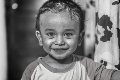 Close-up portrait of smiling boy at home