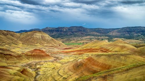Idyllic view of landscape at painted hills against cloudy sky