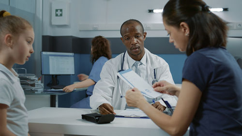 Mother reading prescription in hospital