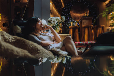 Young woman relaxing on sofa at home