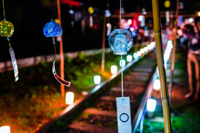 Close-up of illuminated text hanging on street at night