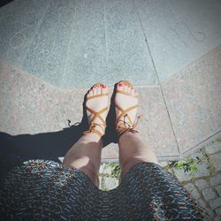 Low section of woman standing on tiled floor