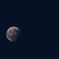 Low angle view of moon against clear sky at night