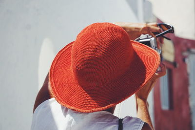 Rear view of woman wearing hat photographing from camera