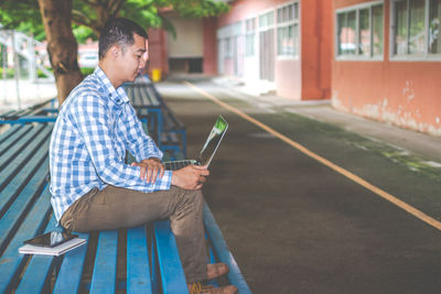 Man using technologies while sitting at table